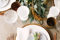 20 an elegant modern fall wedding tablescape with a greenery, rust and white bloom runner, white porcelain, wooden chargers and copper cutlery
