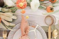 24 a romantic modern pastel tablescape with bright and neutral blooms and fruits on the table plus gilded touches