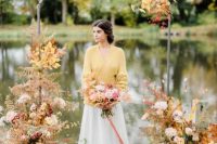 25 a sophisticated modern wedding arch with bright fall leaves, blush, white and mustard blooms and a gorgeous lake view is wow