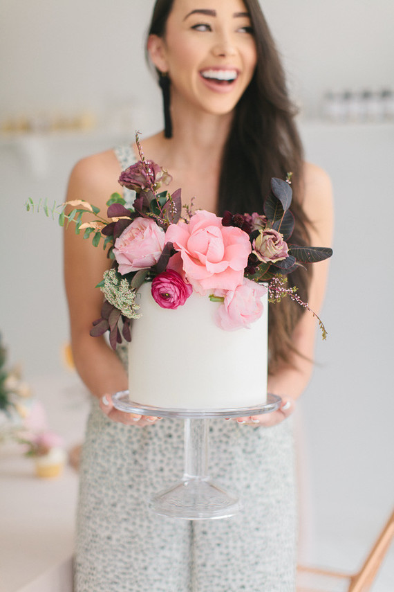 a cool modern bridal shower cake in white, with lush pink, hot pink and dark blooms and foliage is amazing
