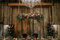 31 a fantastic fall rustic wedding reception with lots of pumpkins on the floor, bold blooms and neutral ones, greenery and colorful ribbons
