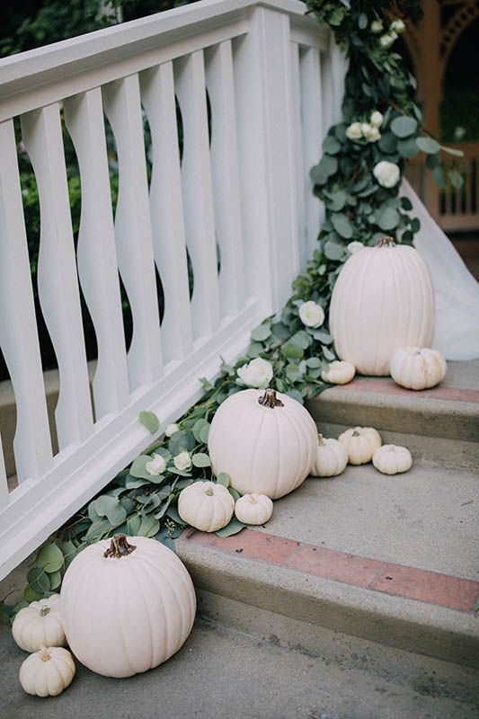 style your stairs with white pumpkins and eucalyptus to give the location and more wedding-like look