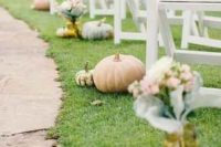 pumpkins are perfect to decorate a fall wedding’s ceremony space