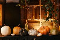 45 a gorgeous rustic fall wedding dessert table with lots of pumpkins and cascading greenery and a cake and a pie is gorgeous