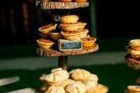 50 delicious home pies served on a wood slice stand is a cool and cozy idea for a rustic fall wedding, substitute a cake with them