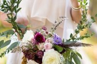 a beautiful hoop wedding bouquet with much greenery, white and bold blooms and lavender is a cool idea for a boho bride