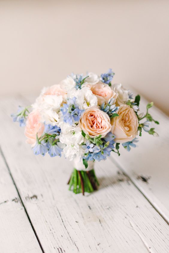 a beautiful pastel wedding bouquet with blue hydrangeas, blush peonies, greenery and white blooms is a lovely idea to rock