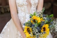 a beautiful wedding bouquet of sunflowers, baby’s breath, thistles and greenery is a chic and bold idea for any summer bride