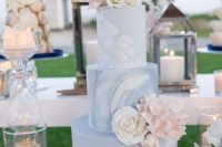 a blue marble wedding cake topped with blush and white blooms is a great and chic idea for a pink and blue wedding