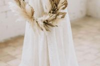 a boho hoop wedding bouquet with dried fronds and pampas grass is a chic idea for a summer or fall wedding