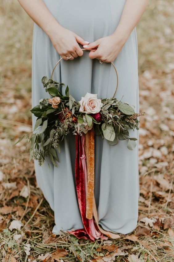 a bold hoop wedding bouquet with lush greenery, pastel blooms and bold ribbons of velvet is a chic and pretty idea for a bridesmaid