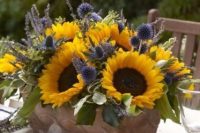 a bold summer wedding centerpiece of sunflowers, allium, lavender and foliage is a perfect solution for a colorful summer wedding