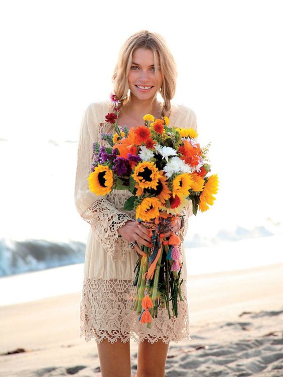 a bright and fun wedding bouquet with sunflowers, purple, red, orange and white blooms and greenery is a gorgeous idea for a boho bride