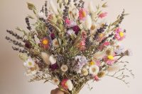 a bright dried and natural flower wedding bouquet with daisies, astilbe, lavender, grass, twigs is a fun idea for a summer boho bride