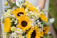 a chic and simple rustic wedding bouquet with sunflowers, billy balls, daisies and greenery is a lovely solution for a summer wedding