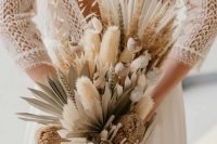 a chic dried flower wedding bouquet with fronds, bunny tails, proteas, grasses and seed pods and wheat is a lovely idea for a summer or fall boho bride