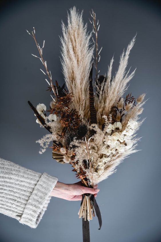 a dreamy dried flower wedding bouquet of pampas grass, wheat, blooms, fronds and lavender is a cool idea for fall or summer