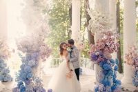 a fantastic wedding altar decorated with ombre blooms from white to pink, blue, lilac and white is amazing