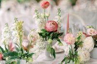 a lovely pastel secret garden wedding tablescape with neutral and pink blooms and greenery, a lace tablecloth and pink candles is a chic idea
