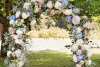 a lovely wedding arch covered with eucalyptus, white, blue and pink hydrangeas is an amazing idea for a spring or summer wedding