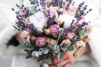 a lovely wedding bouquet of lavender, cotton, pink roses, twigs and eucalyptus is a pretty solution for a summer wedding