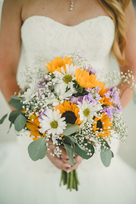 a pretty and relaxed summer wedding bouquet of sunflowers, white and purple blooms, baby's breath and eucalyptus