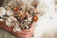 a pretty dried wedding bouquet of lunaria, pampas grass, baby’s breath, dried daises and fern is a lovely idea for both a bride or bridesmaid
