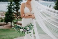 a pretty hoop wedding bouquet with white and blue blooms and lots of greenery is a stylish idea for a spring bride