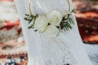 a simple and delicate hoop wedding bouquet with greenery and white roses is a lovely idea for a spring or summer wedding