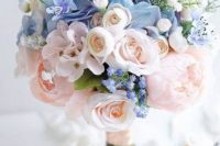 a subtle wedding bouquet of blush and blue flowers plus pink ribbons is a very beautiful and stylish idea