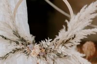 an adorable boho hoop wedding bouquet with pampas grass, dried blooms and leaves is a chic and cool idea to rock