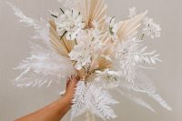 an ethereal dried wedding bouquet with ferns, fronds, white blooms and dried grasses is a fantastic idea for a spring wedding