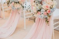 lovely wedding chair decor with pink covers and white, blue and pink blooms and greenery is gorgeous and very chic