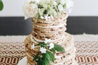 22 a chocolate chip cookie wedding cake with white blooms, white filling and some foliage looks gorgeous and yummy