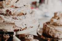 23 a cinnamon bun wedding cake fully covered with white icing is a delicious dessert for a relaxed brunch wedding