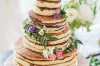 25 a very simple pancake wedding cake topped with Nutella and topped with fresh blooms and greenery can be easily DIYed