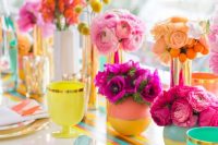 a bold bridal shower tablescape with a colorful runner, bold plates, glasses, color block vases and colorful blooms is a gorgeous idea to rock