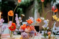 a colorful modern bridal shower tablescape with bolc blooms, pink bowls, colored glasses is a very refined and beautiful solution