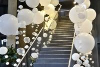 a ladder in your wedding venue can be decorated like that – with white balloons of various sizes, they give a modern feel to the space