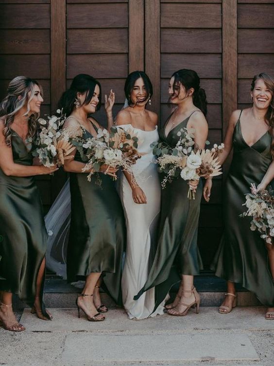 beautiful green slip bridesmaid dresses with asymmetrical skirts and deep V-necklines plus slits are amazing for fall weddings
