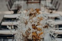 lovely dried flower wedding centerpieces with lunaria, dried blooms in mustard and rust colors and some twigs is a lovely idea for a fall wedding
