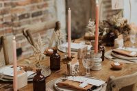 pretty and simple dried flower and bunny tail centerpieces in apothecary bottles, blush and orange candles in tall candleholders