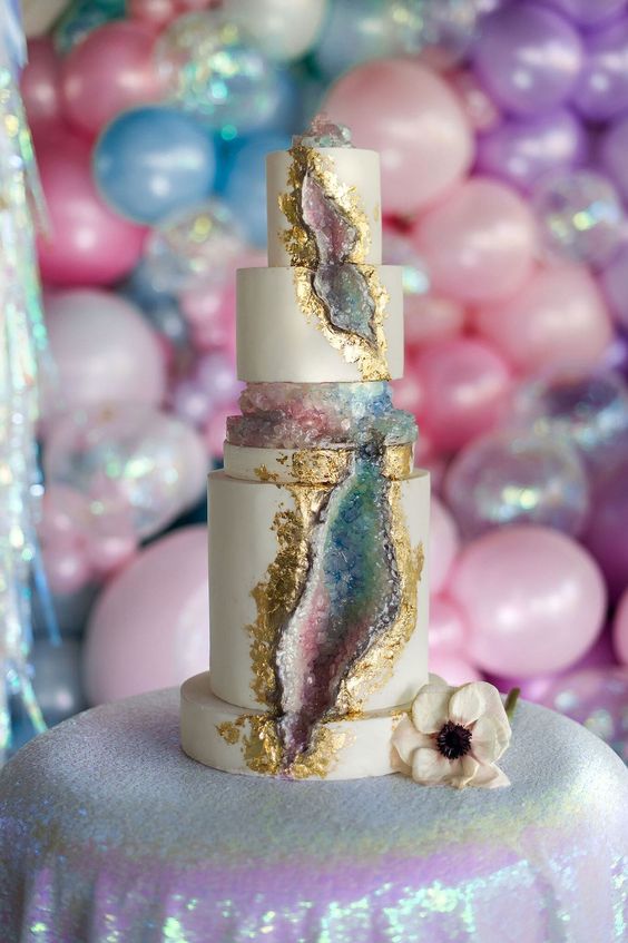 a bold iridescent wedding cake with gold edges and geode touches is a fantastic solution for an iridescent wedding