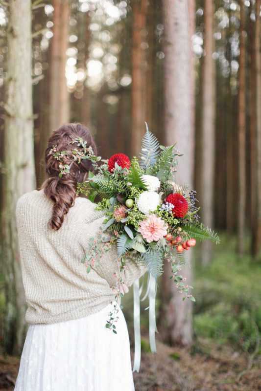 a neutral slouchy sweater with a touch of sparkle over the wedding dress for a woodland bridal look