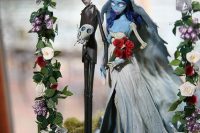 10 moss and Sally and Jack decor with a floral wedding arch is a stunning idea for a Nightmare Before Christmas wedding