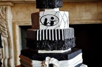 13 a black and white Nightmare Before Christmas wedding cake with various patterns and white blooms is a chic idea