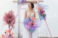 14 a fantastic iridescent wedding arch – a pink arch with purple, blue, pink and spray painted fronds and grasses and a matching wedding bouquet