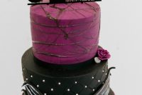 16 a bold black and purple wedding cake with various patterns, a black cake topper and sugar blooms is a stunning idea for your themed Nightmare Before Christmas wedding