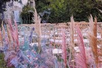 17 an iridescent wedding aisle decorated with bold spray painted blooms, foliage and pampas grass is amazing