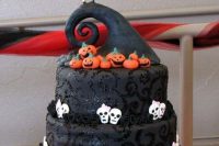 18 a bold Tim Burton wedding cake in black, with white skulls, pumpkinds, Jack and Sally cake toppers is wow